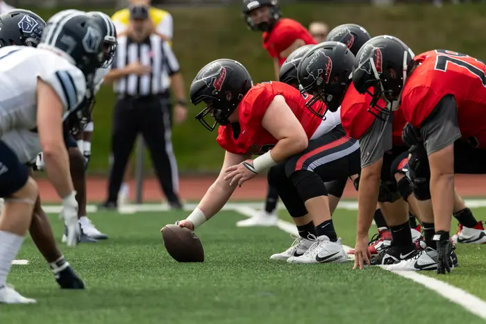 Tartan football players at the line of scrimmage